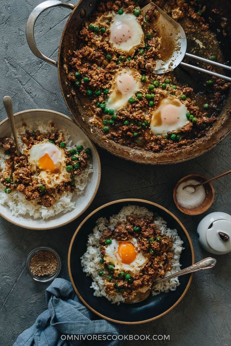 two bowls filled with rice and fried eggs