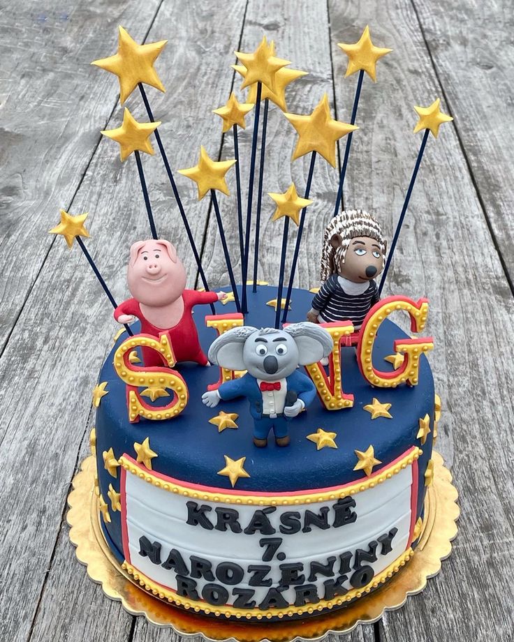 a birthday cake with pep the pig and her family on top is decorated with stars