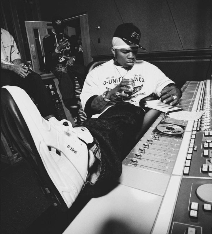 a man sitting in front of a mixing desk