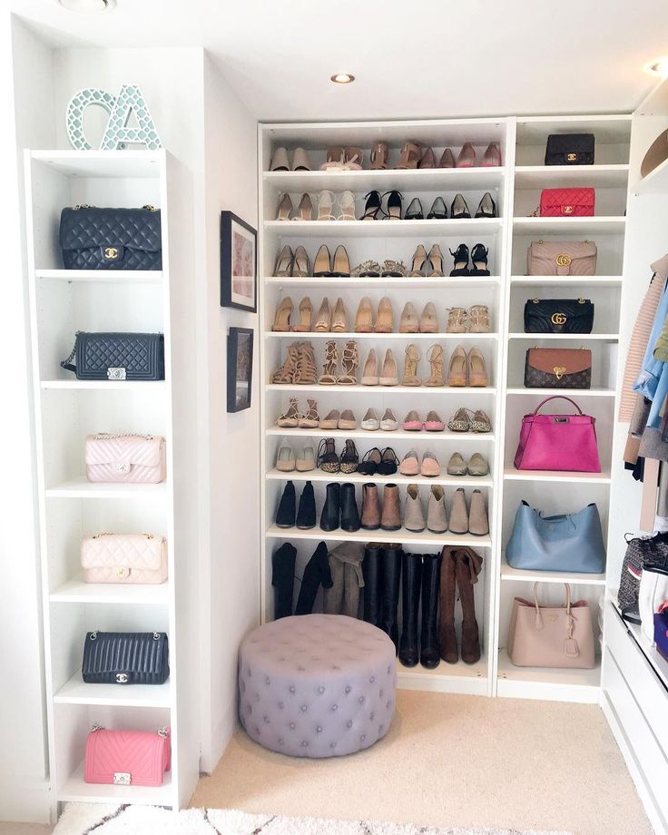 a white closet filled with lots of shoes and handbags next to a shelf full of purses