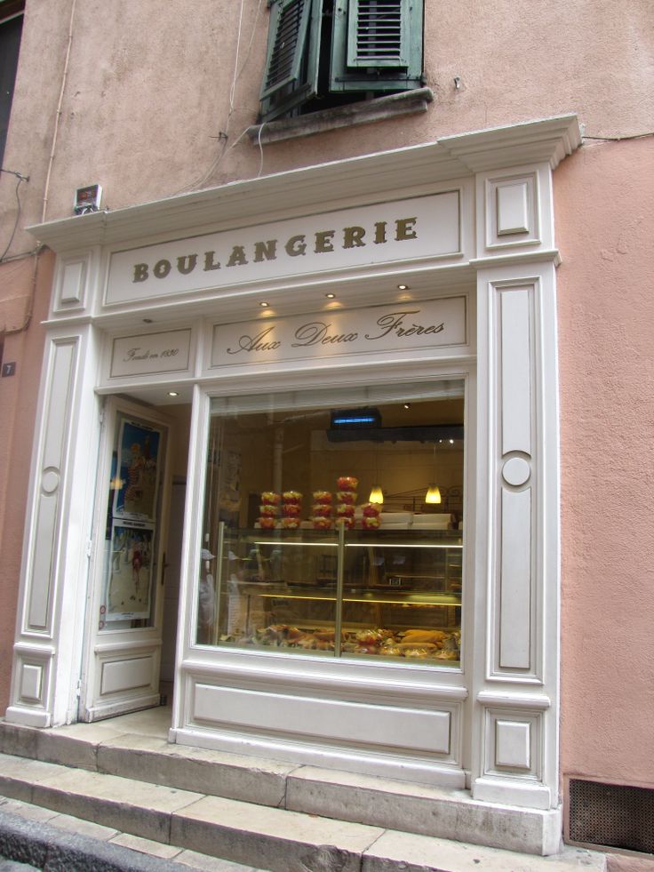 a store front with an assortment of pastries in the window