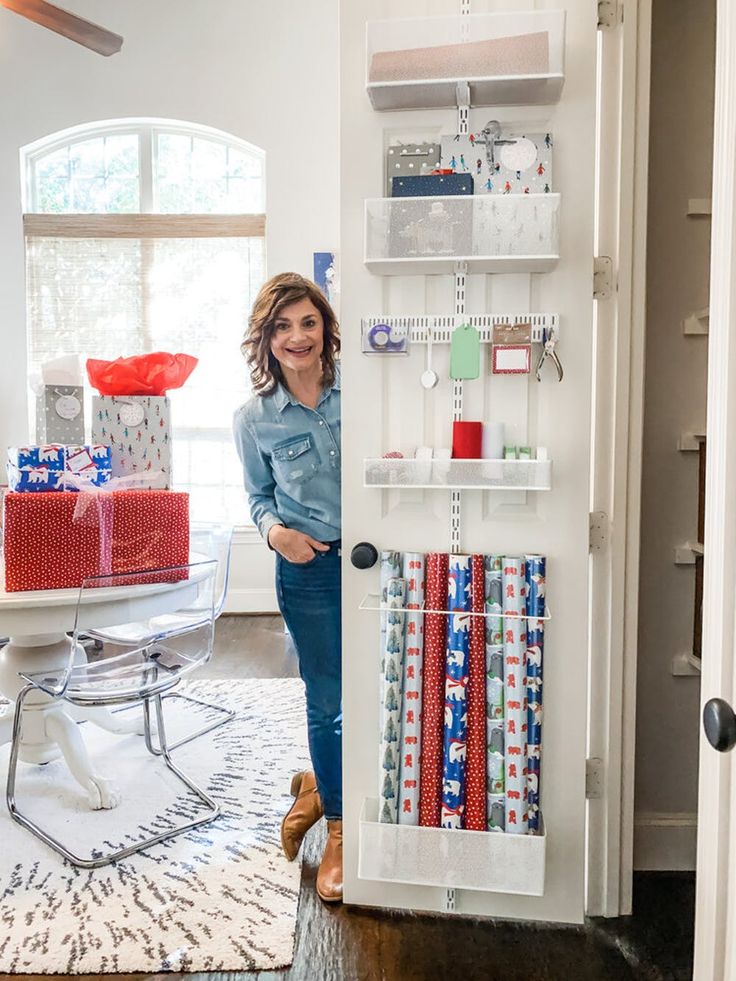 a woman standing in front of a white door with lots of wrappings on it