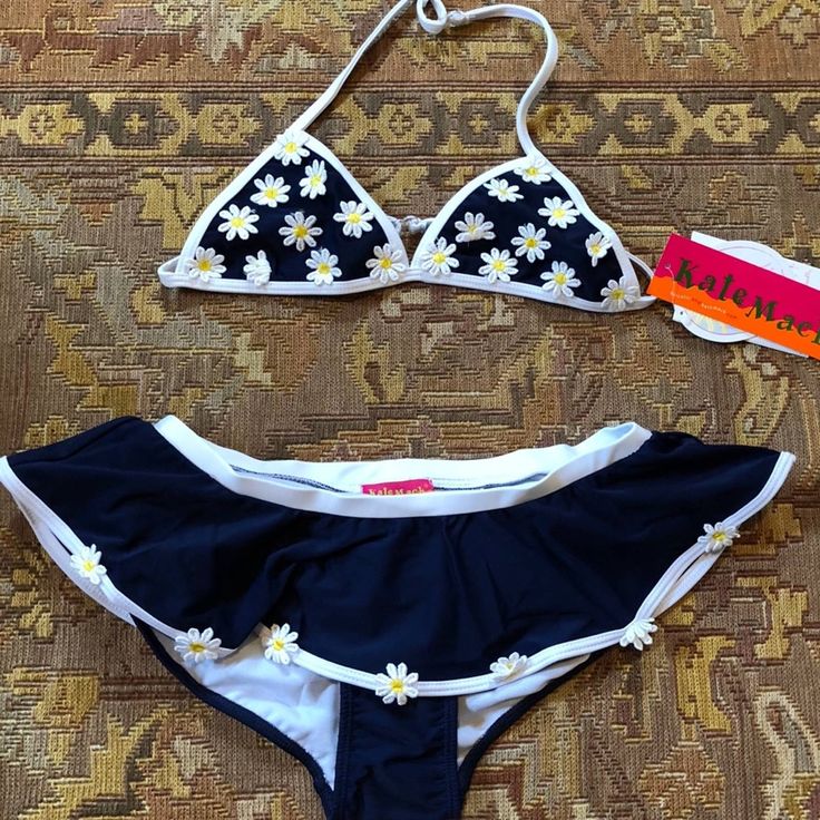 Two Piece Navy Bikini With Daisy Appliqus On Top And Along Ruffle Of Bottom. Size 16. New With Tags, Never Been Worn. Hygienic Liner Is Attached. Comes From A Smoke Free Home. Cute Fitted Swimwear For Spring, Cute Stretch Swimwear For The Beach, Playful Blue Spring Tankini, Fitted Summer Playwear Tankini, White Stretch Swimwear For Fun, Cute Fitted Tankini For Playwear, Fun White Stretch Swimwear, Playful Blue Fitted Tankini, Cute Fitted Swimwear For Beach Season