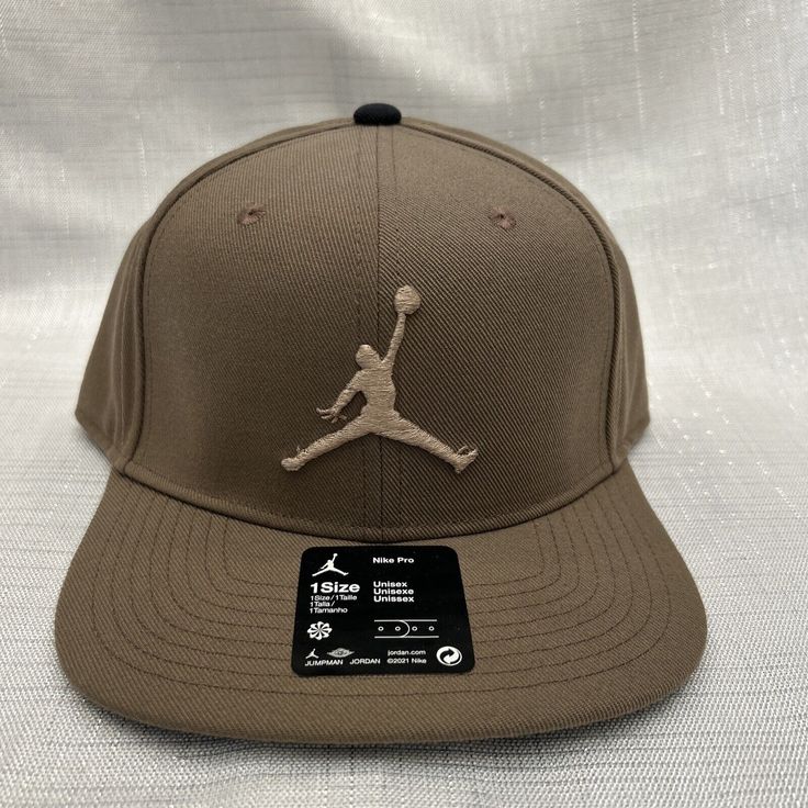 Elevate your style with this Air Jordan Brown Jumpman Hat Snapback Cap for Men. Featuring the iconic Jumpman logo, this adjustable hat is made of high-quality polyester and canvas fabric that is perfect for any season. The classic sports and logo theme of this hat makes it a great choice for casual and travel occasions. The versatile design of this snapback cap makes it suitable for any outfit. Whether you're a fan of the Jordan brand or simply looking for a stylish and comfortable accessory, th Brown Baseball Cap With Flat Bill, Adjustable Brown Snapback Hat With Curved Visor, Adjustable Snapback Hat For Baseball Season, Adjustable Snapback Hat With Curved Visor For Baseball Season, Adjustable Fit Baseball Cap With Curved Brim, Brown Sports Hat With Curved Bill, Brown Snapback Hat For Sports With Curved Bill, Sporty Brown Baseball Cap With Curved Brim, Adjustable Brown Trucker Hat With Curved Visor