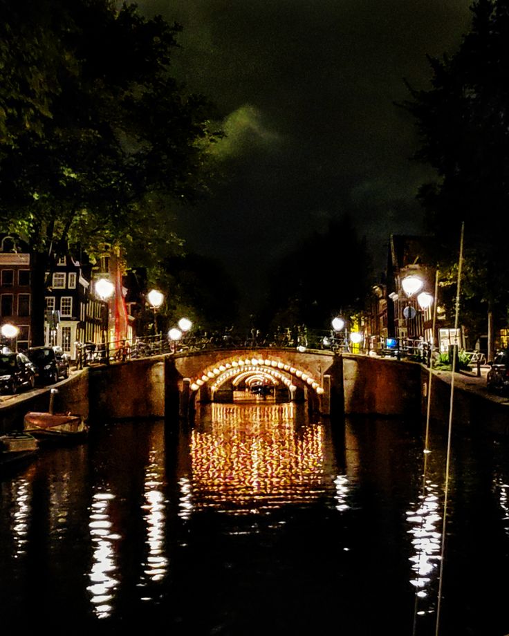 a bridge that is over some water at night