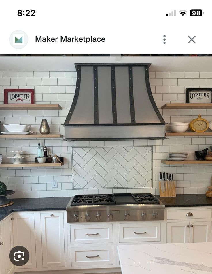 a stove top oven sitting inside of a kitchen next to white cupboards and shelves