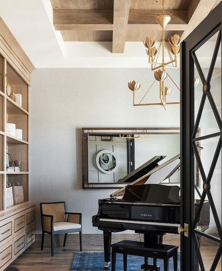 a living room with a grand piano in the center and a mirror on the wall