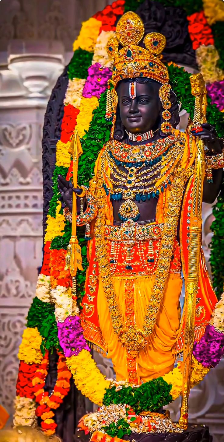 an idol is displayed with flowers around it