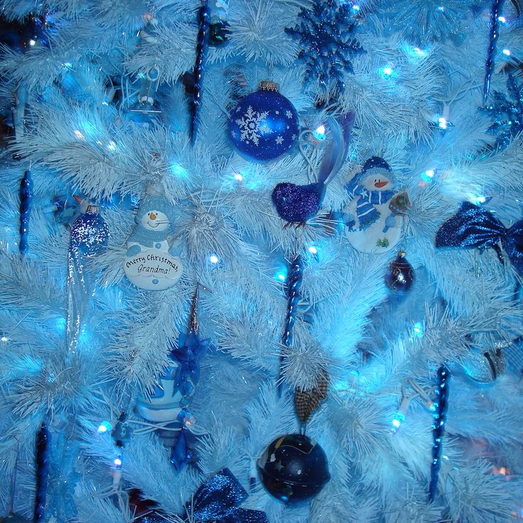 a blue christmas tree with ornaments on it