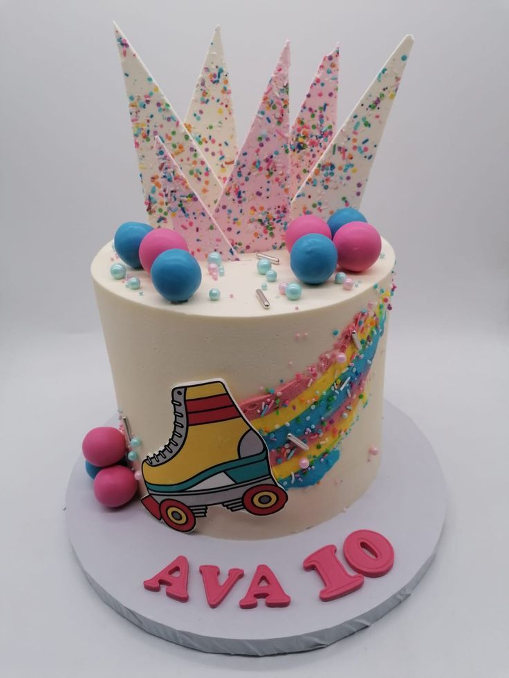 a birthday cake decorated with roller skates and sprinkles on the top