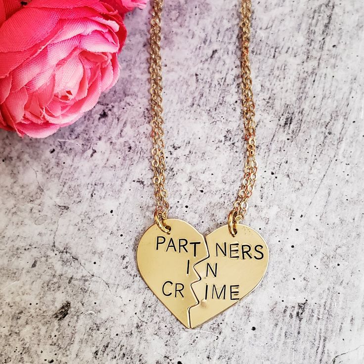 "Celebrate your friendship with this funny jewelry set for two! These are TWO beautiful broken heart necklaces hand-stamped as one with the phrase, \"PARTNERS IN CRIME\" in uppercase or lowercase font of your choice. When the necklaces are apart, the message on the full necklace isn't clear -- which is great for those of us who love to laugh at ourselves. Show your appreciation for your ride or die, partner in crime! This pair of accessories is a fantastic gift for your best friend for their bir Personalized Couples Necklaces For Anniversary, Personalized Couples Necklaces For Anniversary Gift, Personalized Couples Necklaces For Mother's Day, Personalized Couples Necklace For Anniversary, Couples' Heart Charm Jewelry For Gifts, Couples' Heart Charm Jewelry For Valentine's Day, Valentine's Day Couples Jewelry With Heart Charm, Couples Jewelry With Heart Charm For Gift, Heart Charm Jewelry For Couples