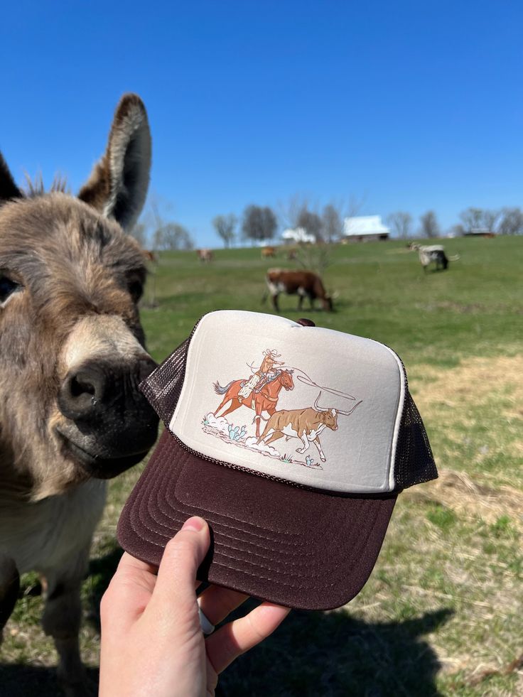 Made here in house at Lost Creek, this design is Direct to Fabric(DTF) on this foam trucker hat. This hat will stand the test of time and be a statement with this timeless Roper Cowgirl design! Exclusive Lost Creek design! Printed on Otto Foam trucker hat Snap back adjustment Final Sale Item due to being made to order Vintage Style Trucker Hat For Rodeo, Novelty Flat Brim Trucker Hat One Size, Novelty Trucker Hat With Flat Brim, Trucker Hats Western, Vintage Trucker Hat For Rodeo, Western Brown Trucker Hat, Trucker Hat Country, Western Style 5-panel Trucker Hat For Rodeo, Western-themed Trucker Snapback Hat