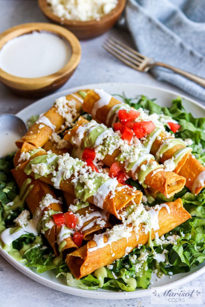 a white plate topped with lots of food next to a bowl of milk and utensils