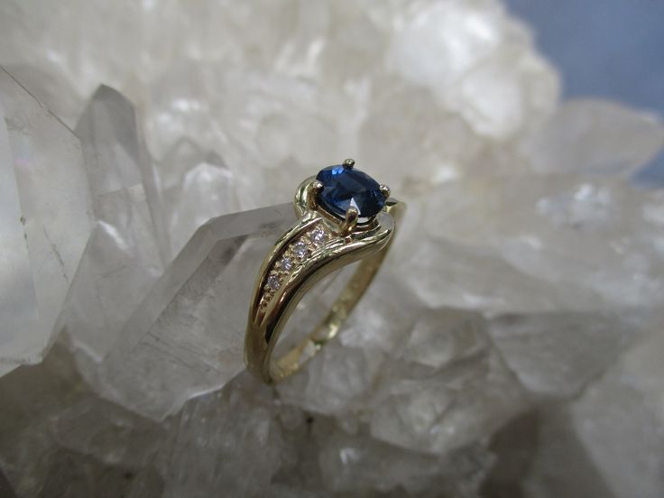 This 14K Gold Ring is set with a beautiful gem grade Sapphire and accented with Diamonds. The Oval Cut Sapphire has great blue color. Not too dark and not too light. It measures 5.5 mm by 4.5 mm and weighs .66 carat. It is a clean, well cut natural stone. There are 8 accenting Diamonds, 4 on each side. The accent Diamonds weigh .05 carat total weight. The ring is about 5/16 inch wide on top and tapers to a narrow band in the back. Low profile settings make this a very wearable ring. It is made i Profile Settings, Sapphire Diamond Ring, 14k Gold Ring, Sapphire Diamond, Oval Cut, Low Profile, Gold Ring, Sapphire Ring, Natural Stone