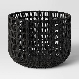 a black wicker basket on a white background