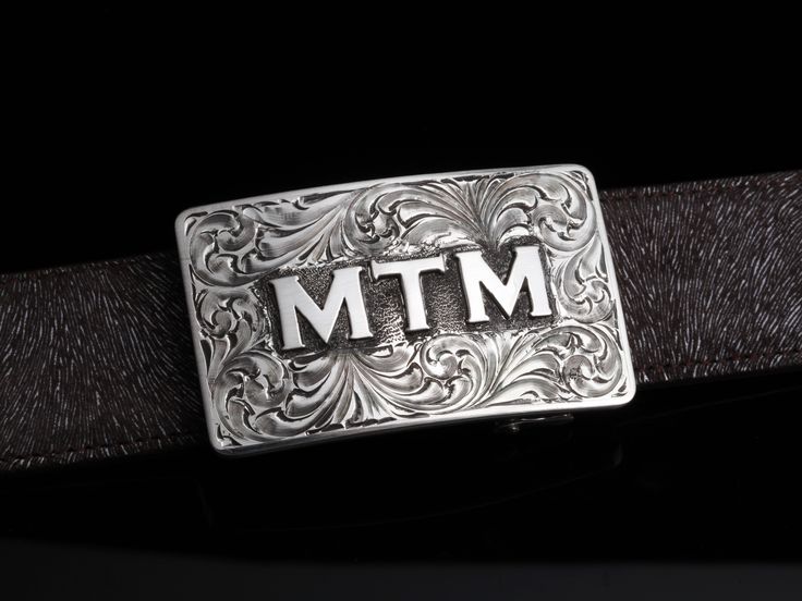 This understated buckle is perfect for those just starting their buckle collections, or for more formal occasions. It’s made from heavy-gauge, hand-engraved sterling silver, and its rectangular face is adorned with some beautiful, delicate scrollwork. This buckle can be paired easily blue jeans or be worn with dressier slacks. This buckle comes in two sizes as well. First smaller size measures approx. 2 1/2" x 1 1/2" and fits all 1.25" belt traps Second larger version measures approx. 3" x 1 3/4 Luxury Formal Jewelry With Silver Buckle, Luxury Silver Jewelry With Engraved Logo, Western Engraved Belt Buckles For Formal Wear, Vintage Engraved Belt Buckles For Formal Occasions, Vintage Engraved Belt Buckles For Formal Wear, Formal Engraved Belt Buckles, Elegant Silver Jewelry With Engraved Logo, Western Engraved Formal Jewelry, Custom Engraved Belt Buckles For Formal Occasions