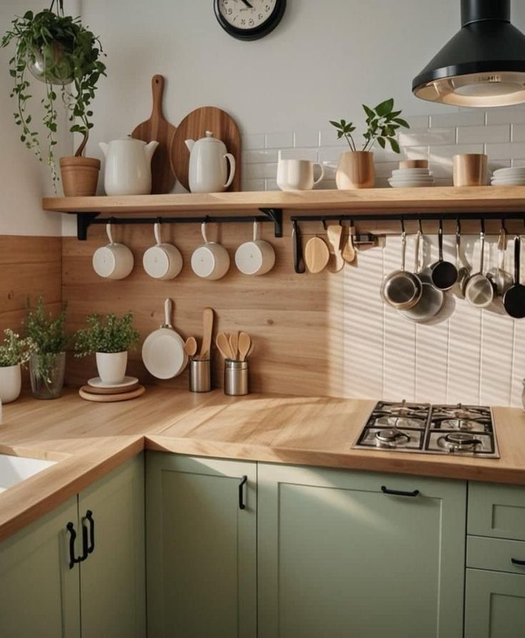 a kitchen counter with pots and pans hanging from it's hooks on the wall