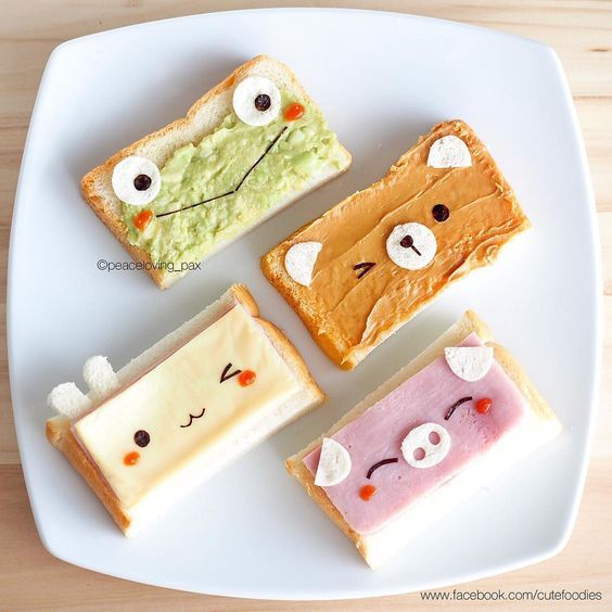 four slices of toasted bread with different designs on them sitting on a white plate