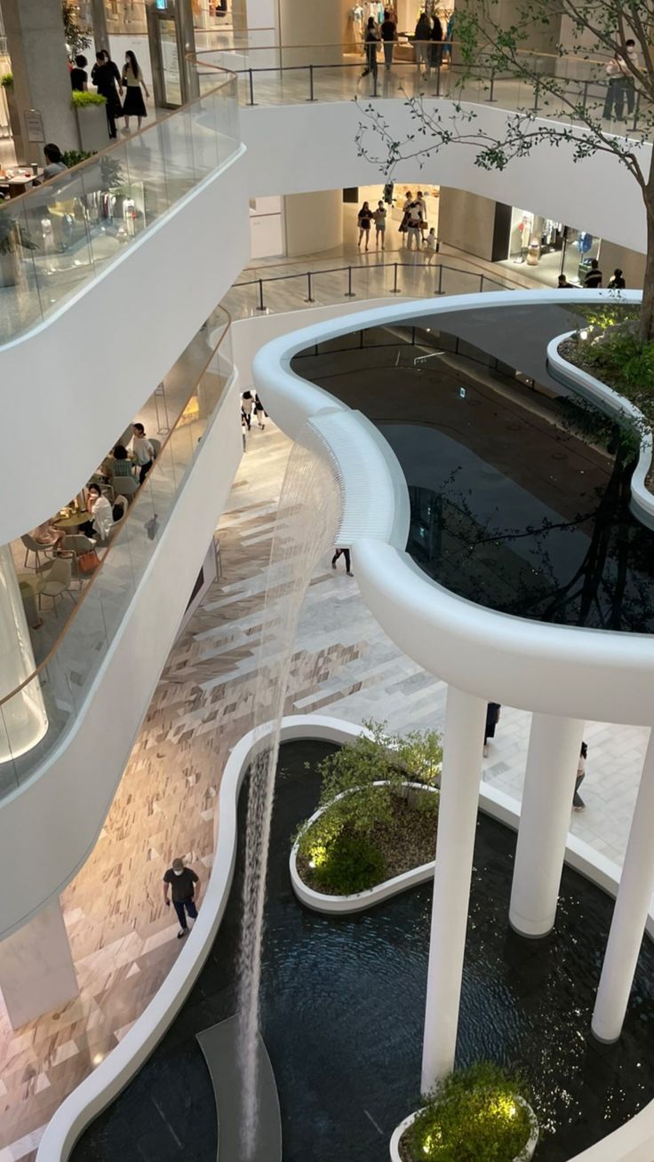 the inside of a shopping mall with people walking around