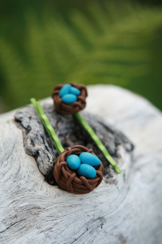 two small blue and brown bird's nest hair pins