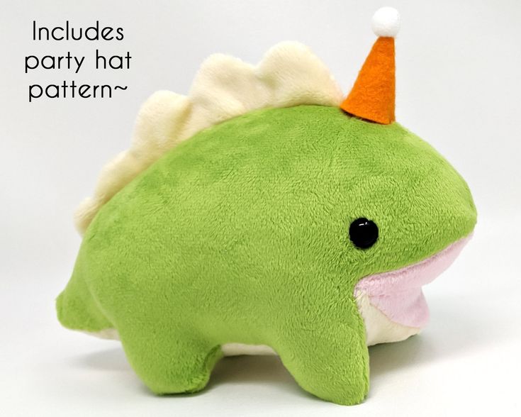 a green stuffed animal with an orange and white hat on it's head that says, includes party hat pattern