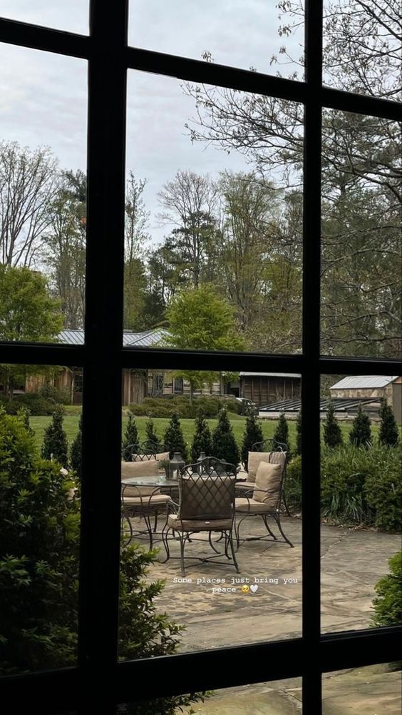 an open window shows a patio with chairs and tables