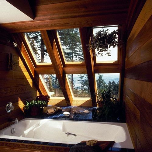 a bathroom with a large bathtub and wooden walls, along with floor to ceiling windows