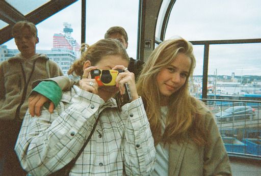 two women are looking through binoculars at something