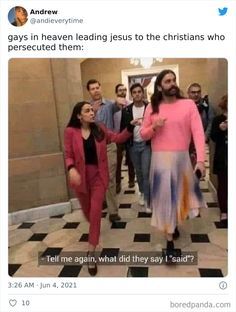 a group of people walking down a hallway with one woman in pink and the other man in blue