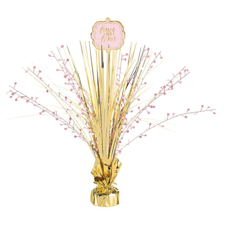 a gold vase filled with pink flowers on top of a table