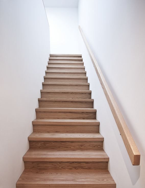 the stairs are made of wood and have no railings or rails on each side