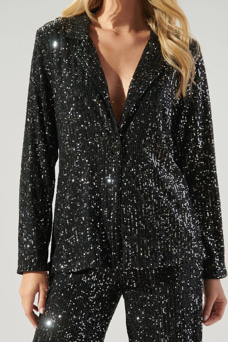 Hit the dancefloor and be the talk of the town in this electrifying jacket. This neo disco look is everything and more. Sequins make this blazer style jacket, highlighting a notched lapel and single button with a slightly tailored fit. Its the perfect piece to elevate any outfit. Wear it on its own, or style it with the matching pants.- Sequins- Tailored- Single button- Lapel- Comes in 2 colorsSize + Fit - Model is 5'10" and wearing size XS- Measurements taken from size S - Chest: 19"- Length: 2 Disco Look, Friday Nights, Talk Of The Town, Blazer Style, Wrap Jacket, Floral Jacket, Tailored Blazer, Matching Pants, The Talk