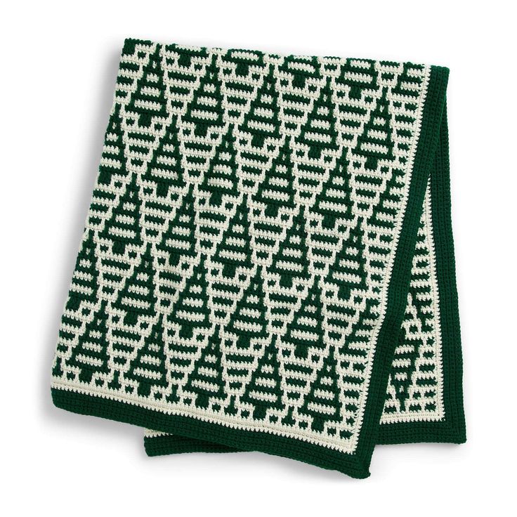 a green and white knitted dishcloth on a white background with an arrow pattern