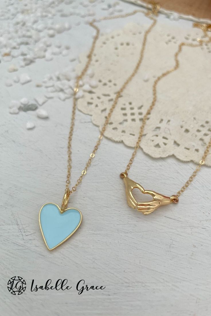 The color of summer shines bright in our Baby Blue Enamel Heart Necklace. A gorgeous and colorful addition to your collection. A beautiful enamel gold plated heart charm sparkles on a 14kt gold fill chain. Charm measures approximately 1/2 inch. Order your unique necklace here! Dainty Heart Necklace For Friendship, Double Heart Enamel Jewelry For Gifts, Blue Heart Charm Jewelry For Friendship, Gold Heart Charm Necklaces For Friendship, Blue Dainty Jewelry For Valentine's Day, Gold Heart Charm Necklace As Gift, Gold Plated Charm Necklaces With Heart Beads For Gift, Gold Plated Heart Beads Charm Necklace For Gift, Enamel Heart Charm Necklace For Gifts