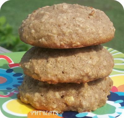 three cookies stacked on top of each other on a colorful plate with flowers in the background