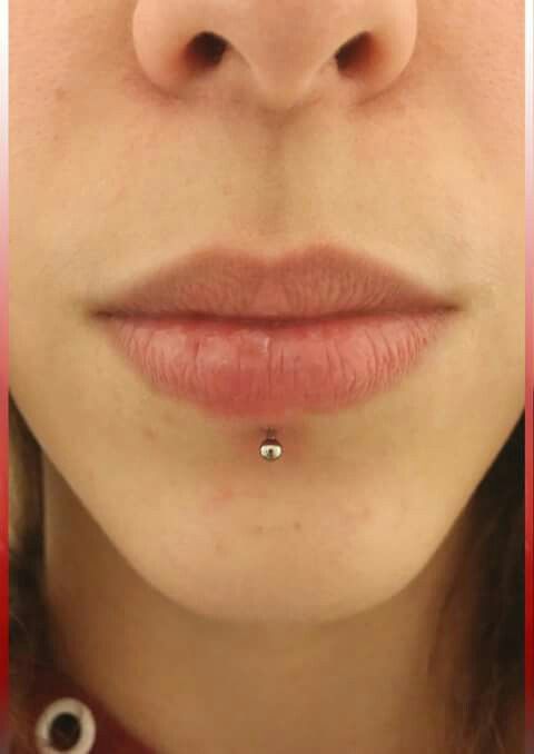 a woman's nose with a piercing in the middle and bottom part of her lip