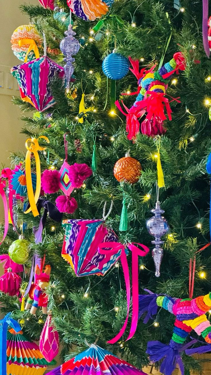 a brightly colored christmas tree decorated with ornaments