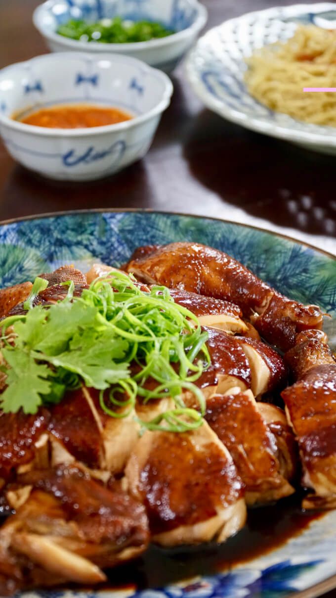 a plate full of food on a table with other plates and bowls in the background