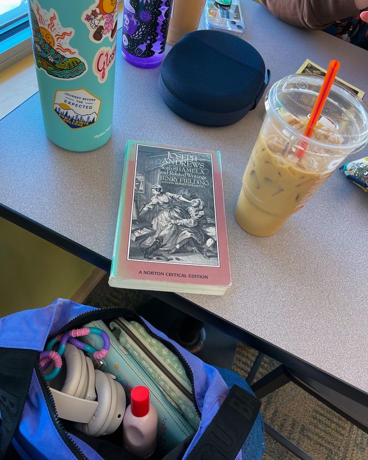 an open book sitting on top of a blue bag