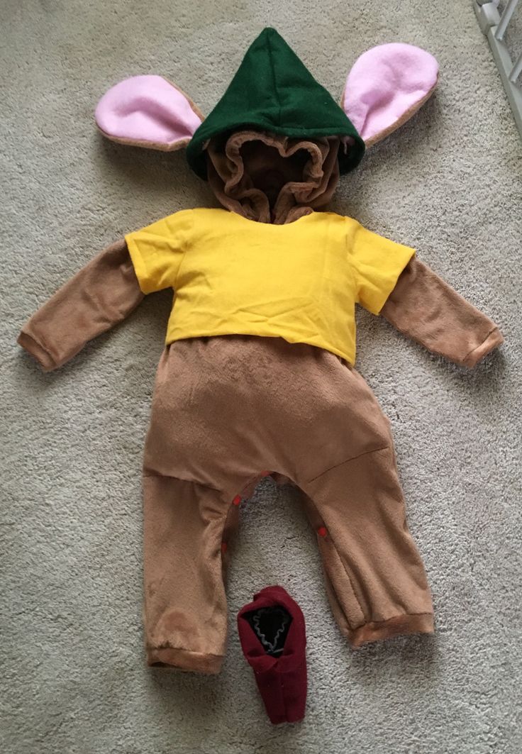 a child's costume laying on the floor next to a pair of shoes