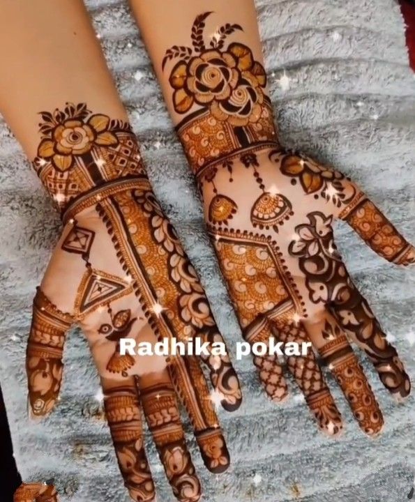 two hands with henna designs on them