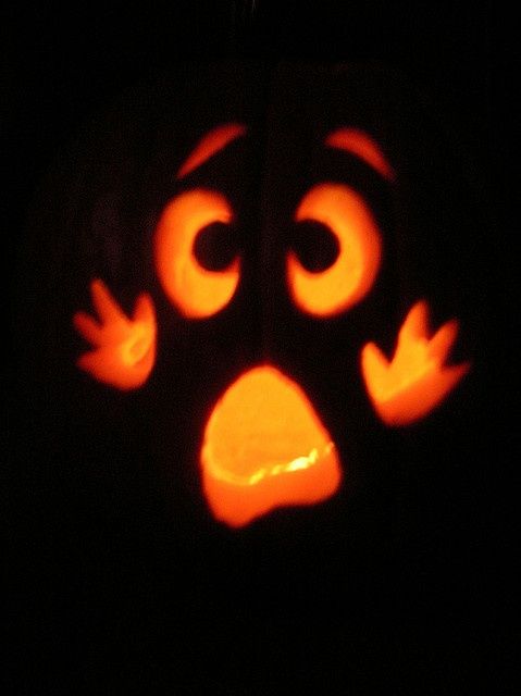 a carved pumpkin with an angry face on it's side and eyes drawn out