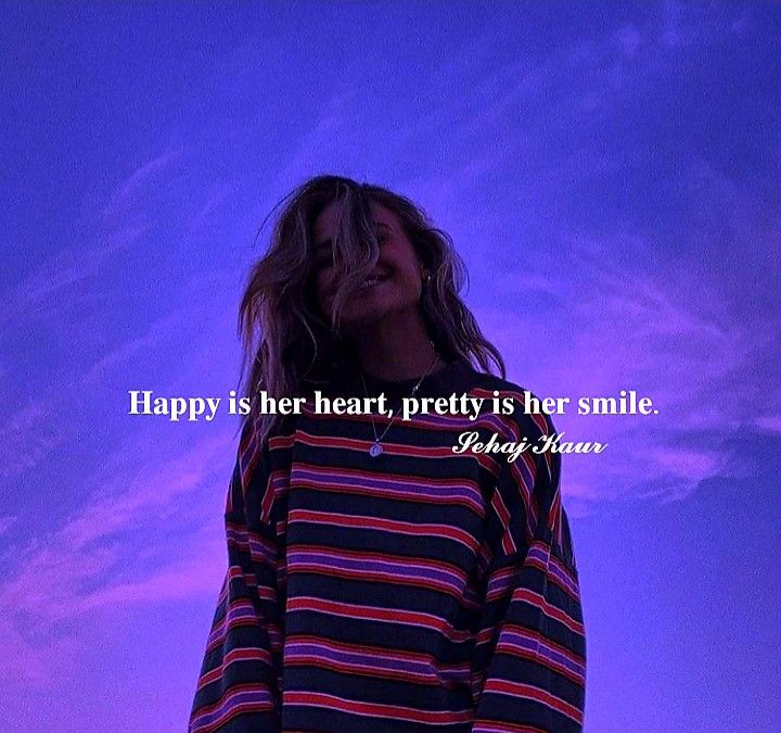 a woman standing in front of a purple sky with the words happy is her heart pretty is her smile