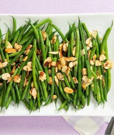 green beans and almonds on a white plate