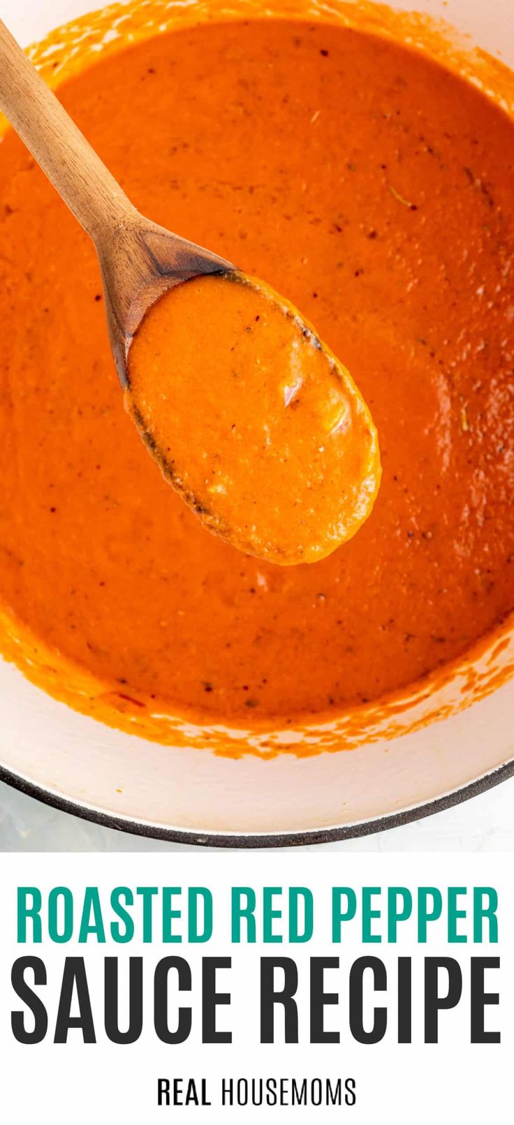 roasted red pepper sauce recipe in a white bowl with a wooden spoon on the side