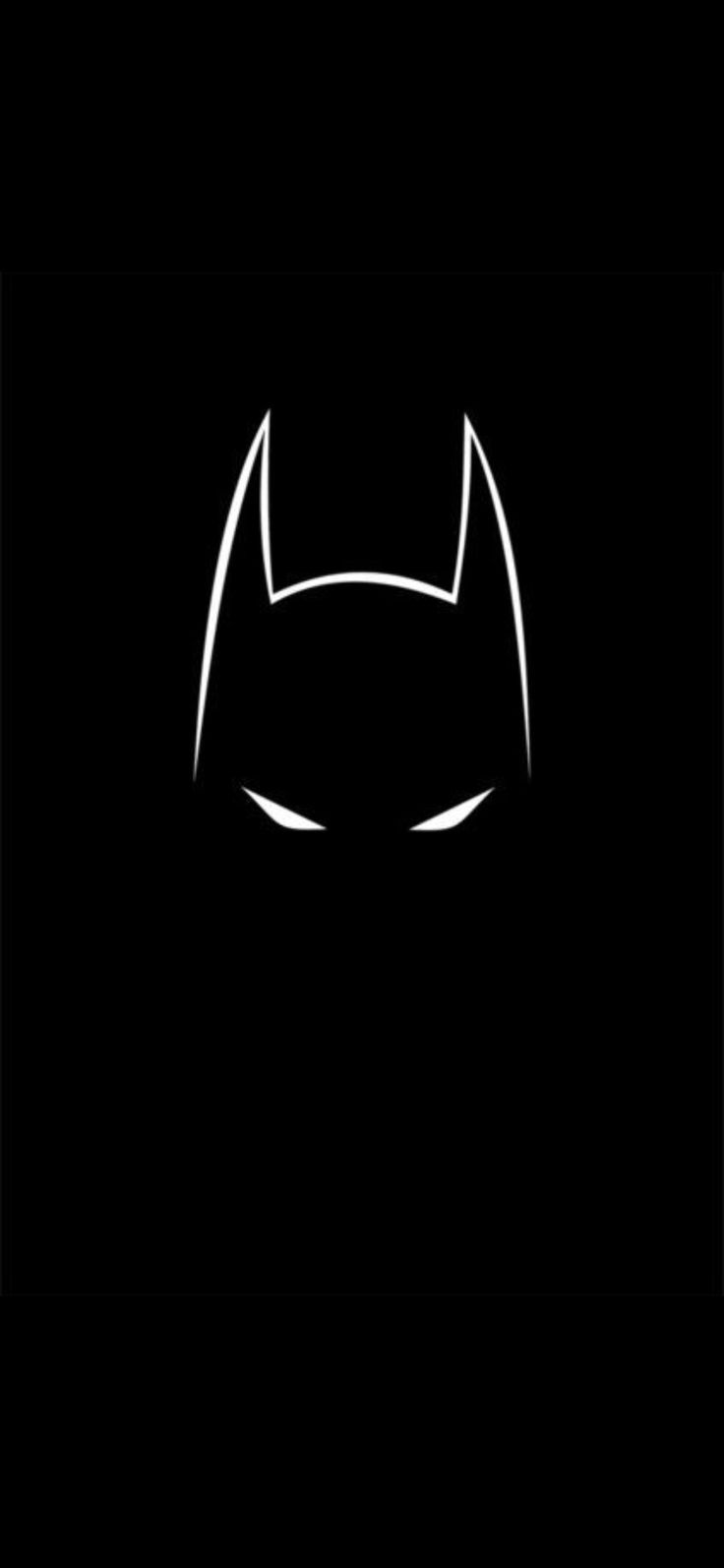 the batman symbol in black and white on a dark background with light coming from behind it