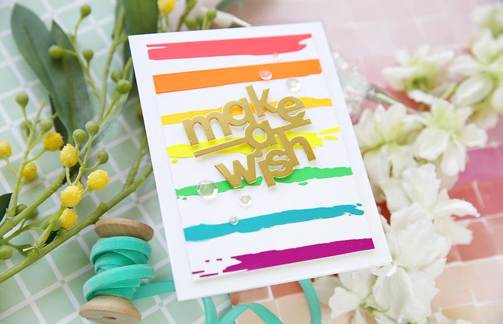 a card with the words make it wish on it next to some flowers and scissors