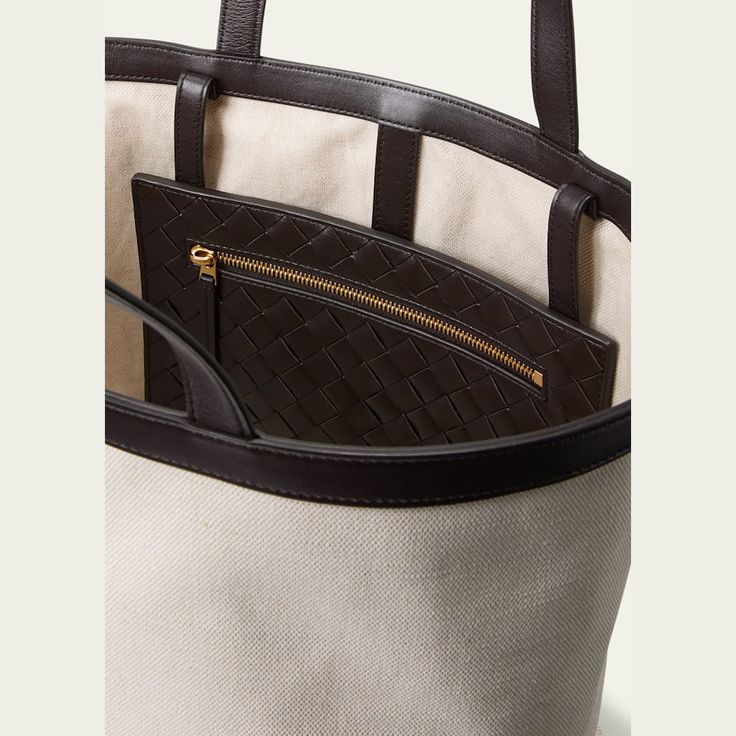 Bottega Veneta tote bag in leather and cotton  Flat shoulder straps  Exterior, front zip pouch can be reversed to be placed inside  Approx. 11.8"H x 11.6"W x 8.3"D Made in Italy Designer Canvas Shoulder Bag With Handles, Luxury Tan Shoulder Bag For On-the-go, Designer Canvas Bag With Top Handle For Errands, Designer Canvas Bag With Top Carry Handle For Errands, Luxury Tan Shoulder Bag For Everyday, Luxury Bucket Tote Bag, Designer Canvas Tote Bag With Top Carry Handle, Designer Canvas Bag With Double Handle For Errands, Designer Canvas Tote Bag With Top Handle