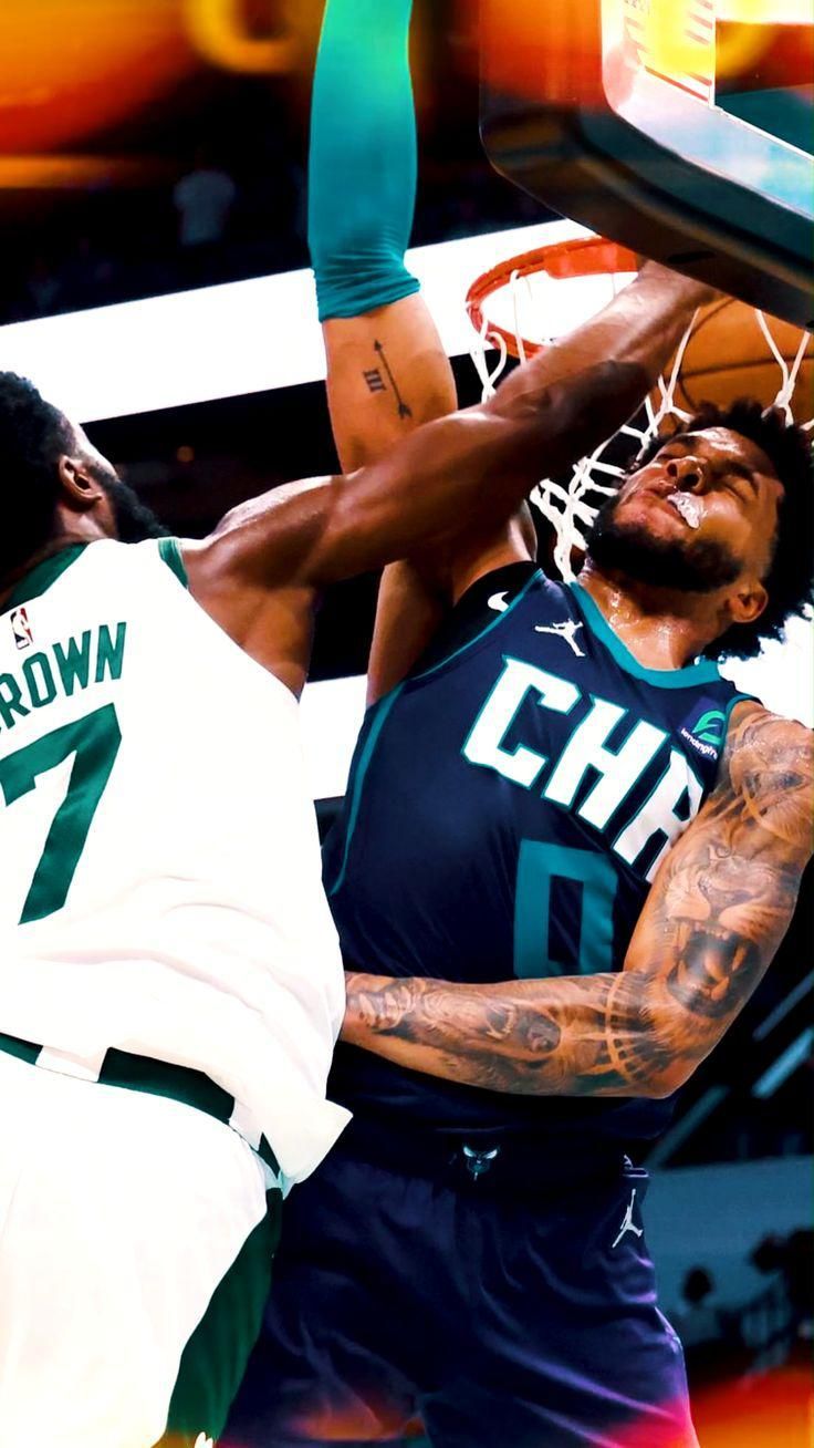 two basketball players in the air during a game