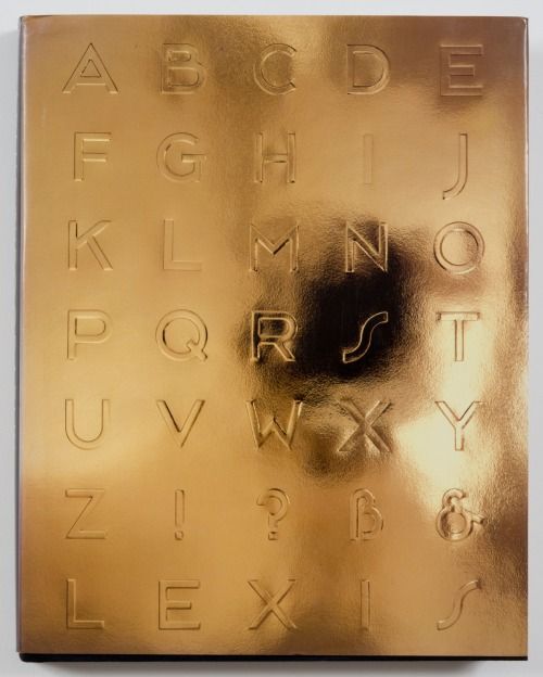 a gold plate with letters and numbers etched into the metal surface that is on display